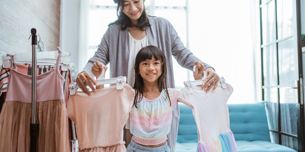 A mother and daughter shopping for clothes together.