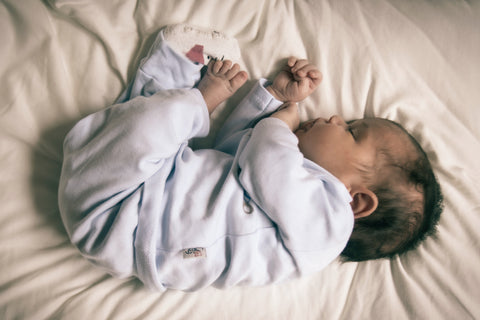 Baby is sleeping in the big bed