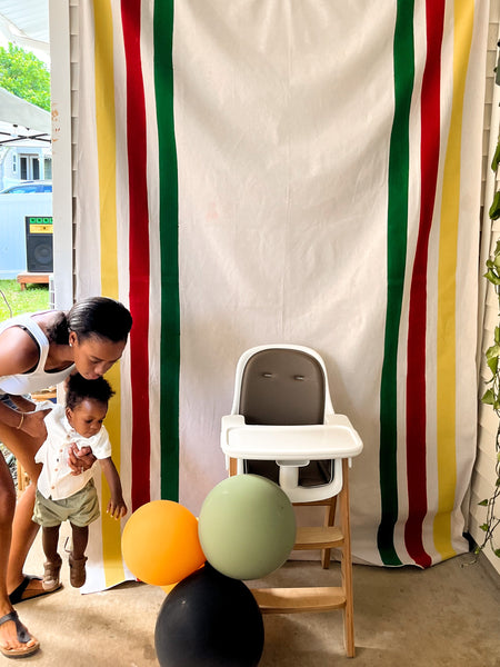 Mom and baby first birthday party onelove backdrop high chair