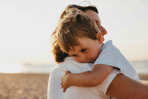 A mother holding a lovely child bathed in sunlight