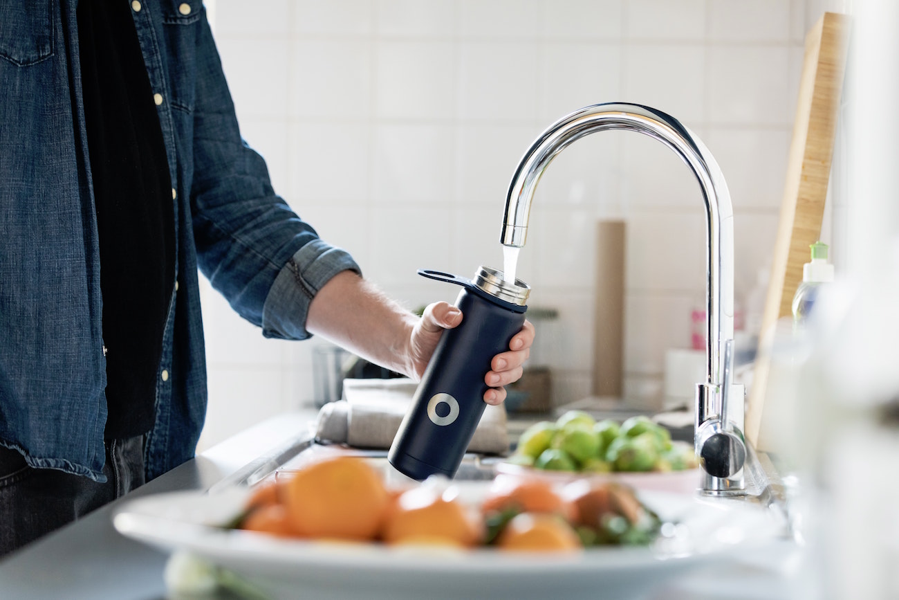 man drinking tap water