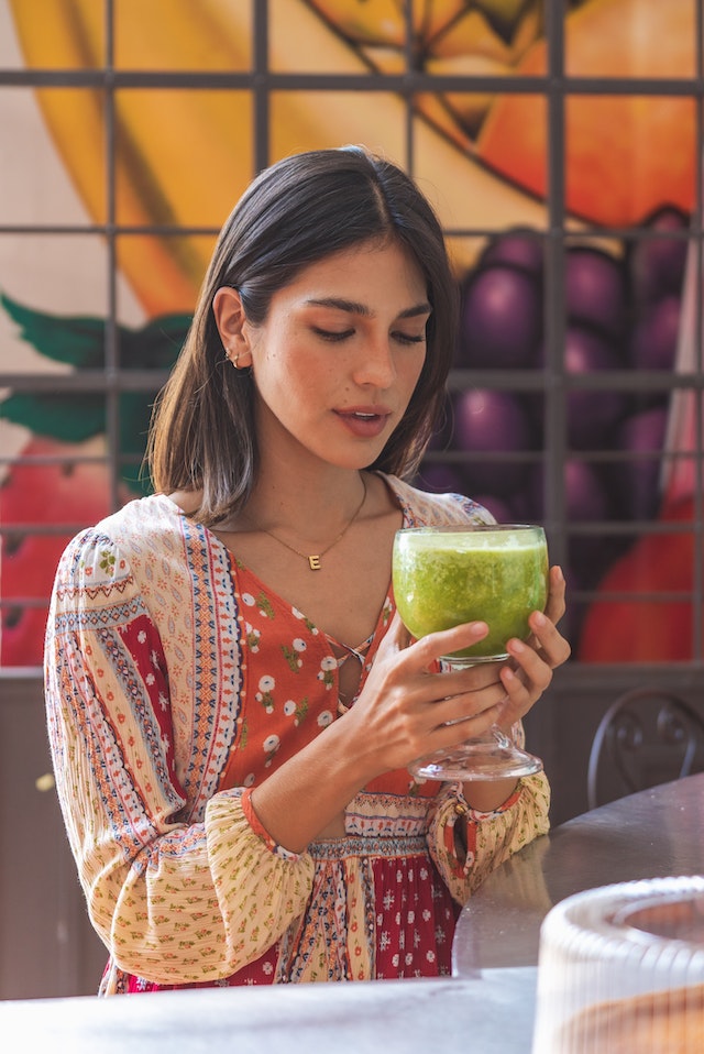 girl drinking green juice