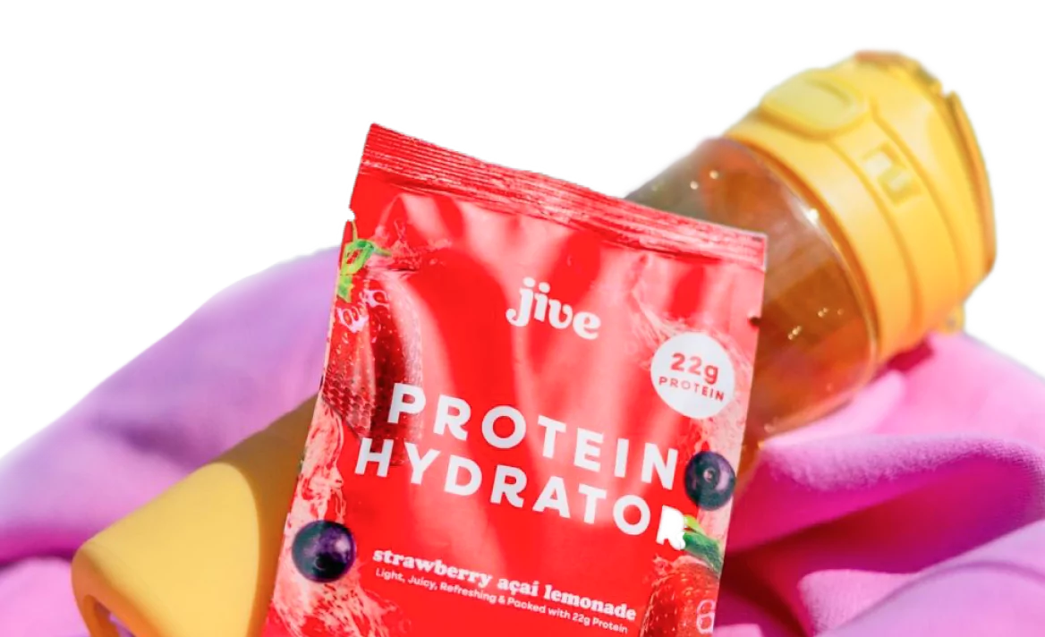 Packet of Jive Protein Hydrator next to a yellow water bottle and purple towel.