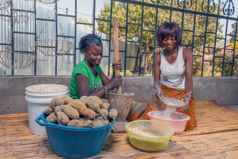 Woman processing baobab seed