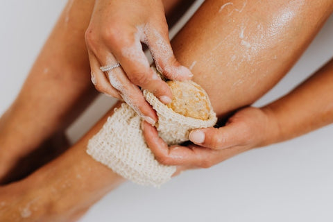 Woman exfoliating legs