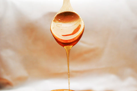 Honey drizzling from a spoon