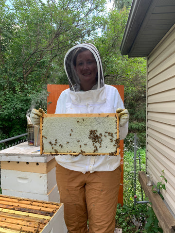 Erin with a full frame of capped honey.