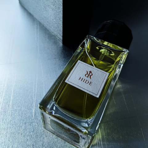 An artistic photo of Hide, Niche perfume by Redolescent, with a dark shadow