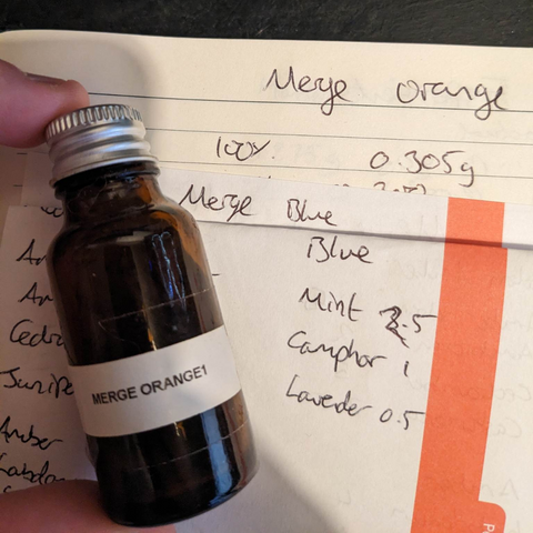 Old perfume making notes containing 'merge blue' and a bottle of merge orange labelled "1"
