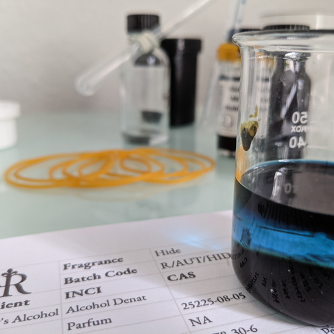 How perfume is made. A beaker with perfume in it showing an intense blue colour
