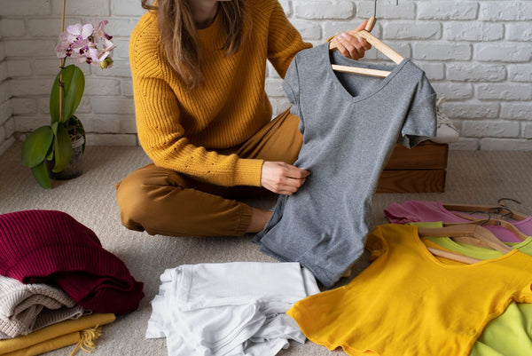 woman-arranges-her-clothes-by-category