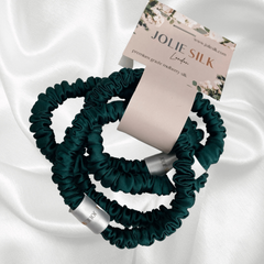 Jolie Silk Glide Silk Hairbands in Emerald. Pack of 4 Mulberry Silk Scrunchies Silk Hair Ties Strong Hold Hair Elastic Ponytail Holder Hair Ties. Hairband. Anti breakage snag-free. pile of silk skinny scrunchies. Emerald Green