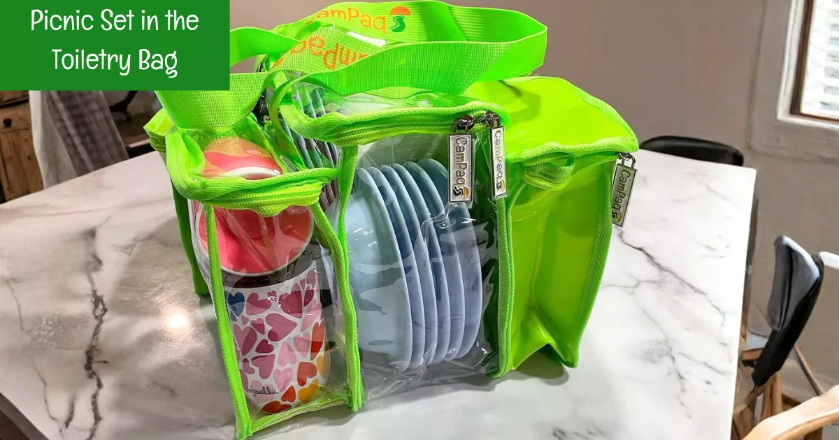 Clear green CamPaq toiletry bag packed with picnic set