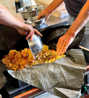 Image of crushed apples being assembled into a "Cheese" ready to press to make cider.