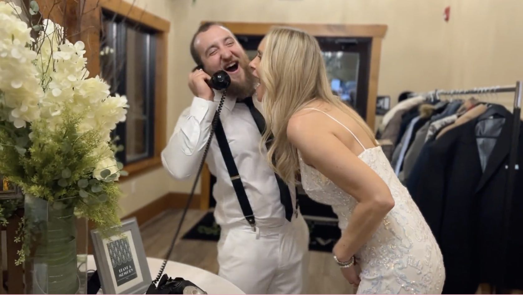 Wedding couple are on a vintage black telephone talking into it