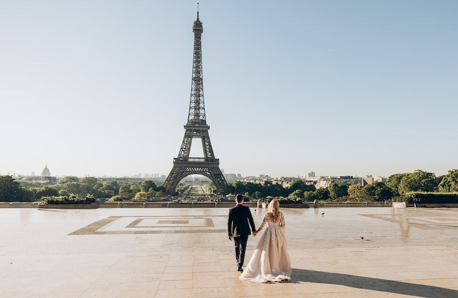 Bride and Groom walking together by the Eiffel Tower