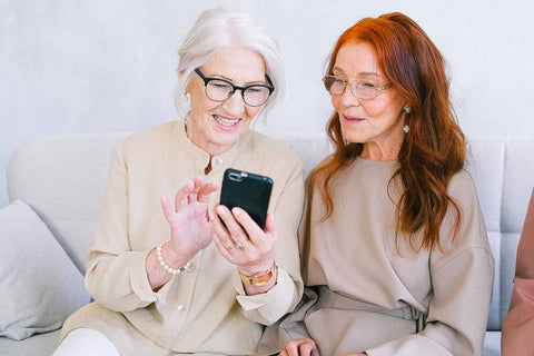 women reading invitation on phone