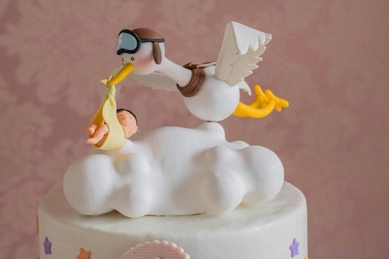 A cake with a stalk decoration flying over the top of the cake.