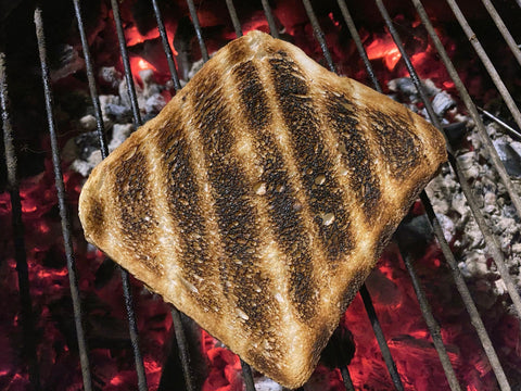 burnt piece of bread on a charcoal grill