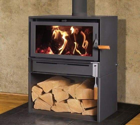 cast iron stove with fire and stacked wood
