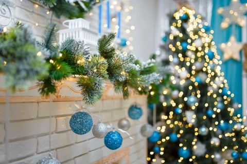 Christmas and New Year cozy living room interior with decorated firtree, fireplace and garlands bokeh