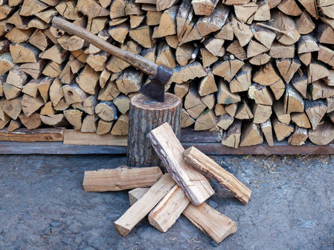 Dry oak firewood stacked in a pile, chopped wood for heating the fireplace.