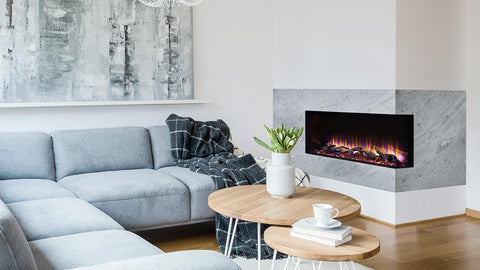 Grey corner lounge in white living room interior with fireplace