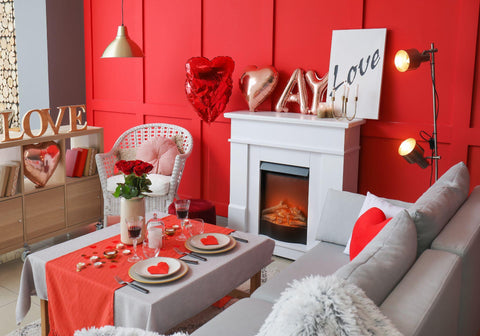 Interior of living room with table served for romantic dinner.