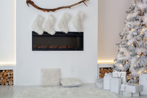 White fireplace is decorated with Christmas socks in living room.