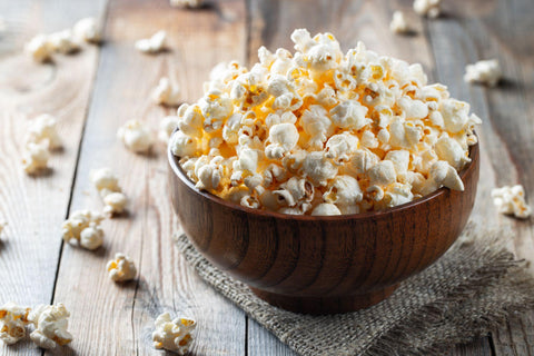 wooden bowl of salted popcorn