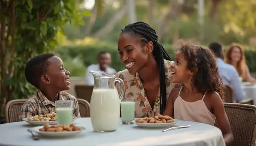 black woman with 2 children enjoying almond and pistachio milk in a patio setting 