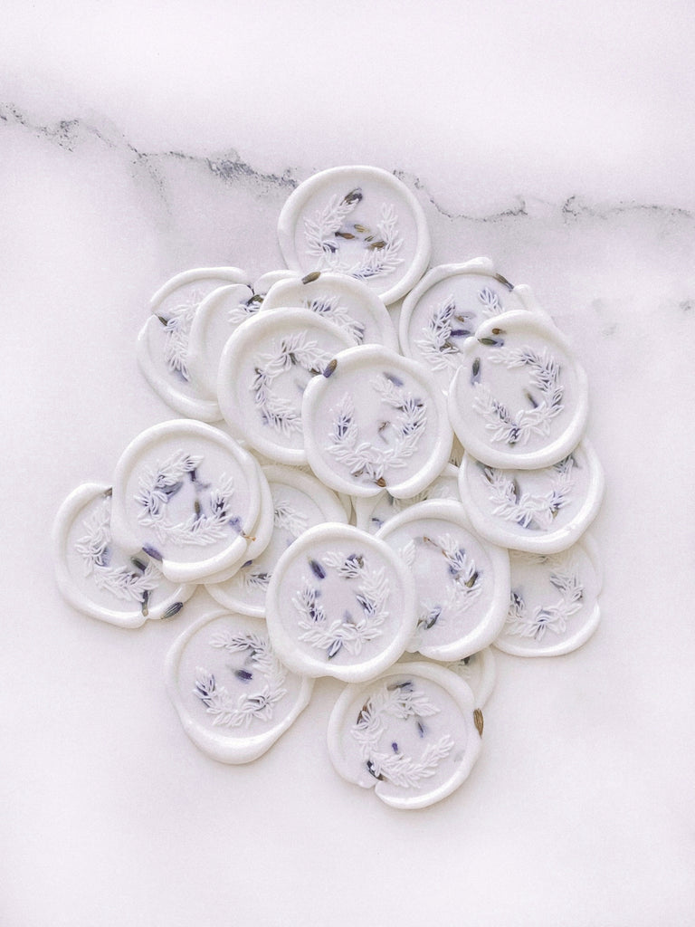 White wax seals with lavender embellishment