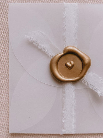 Mini heart gold wax seal on white silk ribbon and small vellum envelope
