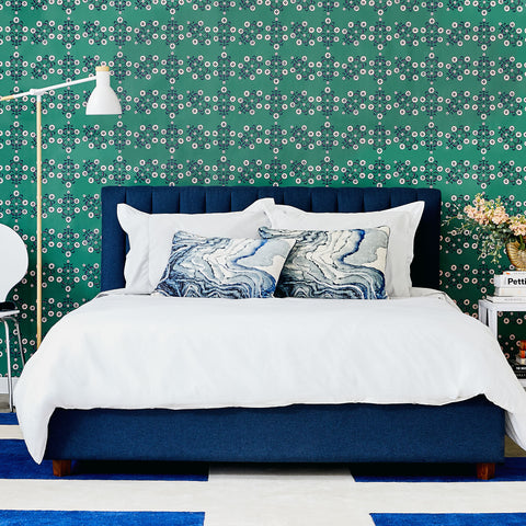 Block Print Floral wallpaper in emerald is beautifully shown behind a navy bed