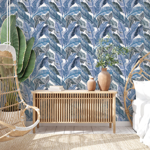 Bahama Palm Peel and Stick Wallpaper in a bedroom with rattan furniture