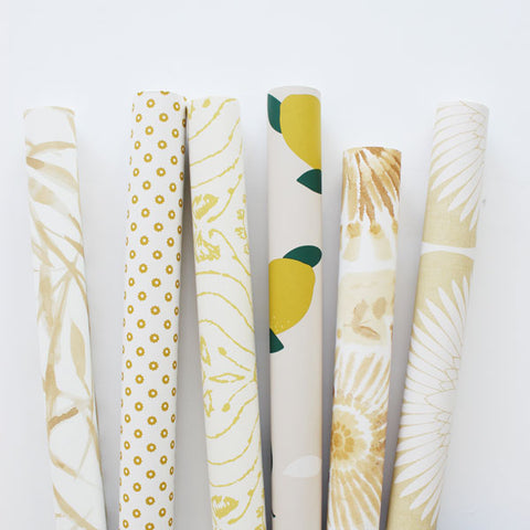 Yellow rolls of peel and stick wallpaper