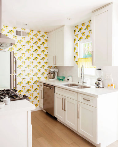 Lemons custom peel and stick wallpaper in a white narrow kitchen