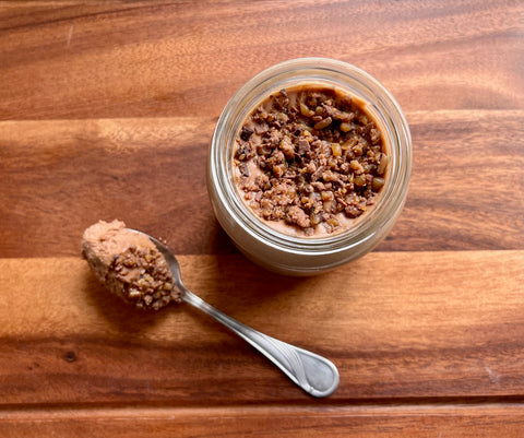 Chocolate Mousse in a jam jar topped with toffee brittle sprinkles.