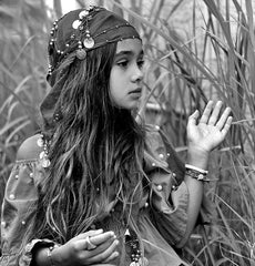 Long brown haired bohemian girl with gypsy jewelry