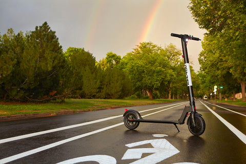 GOTRAX GXL V2 Electric Commuter Scooter for Adults on a bike in the park.