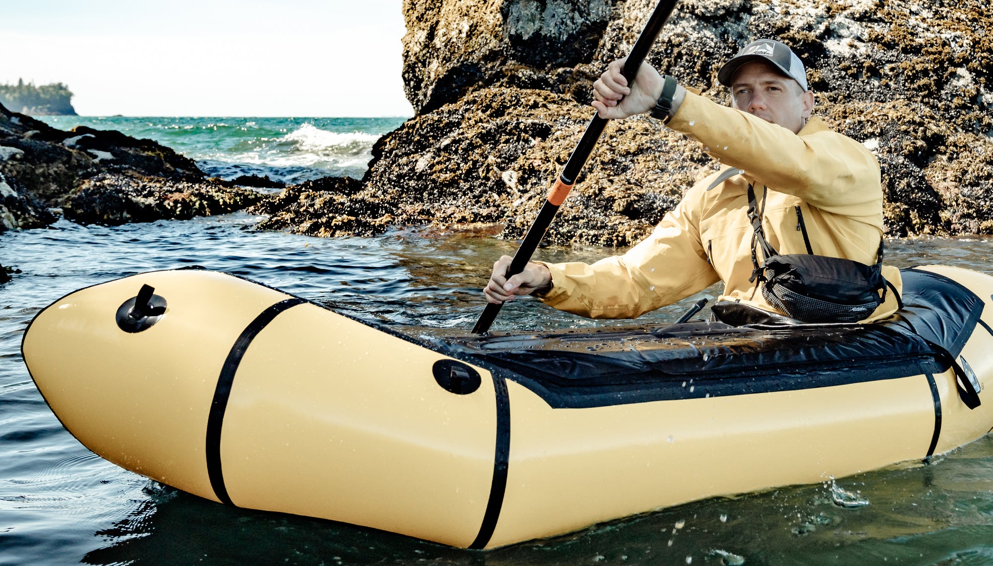 Man in sea kayak wearing crossbody hip pack