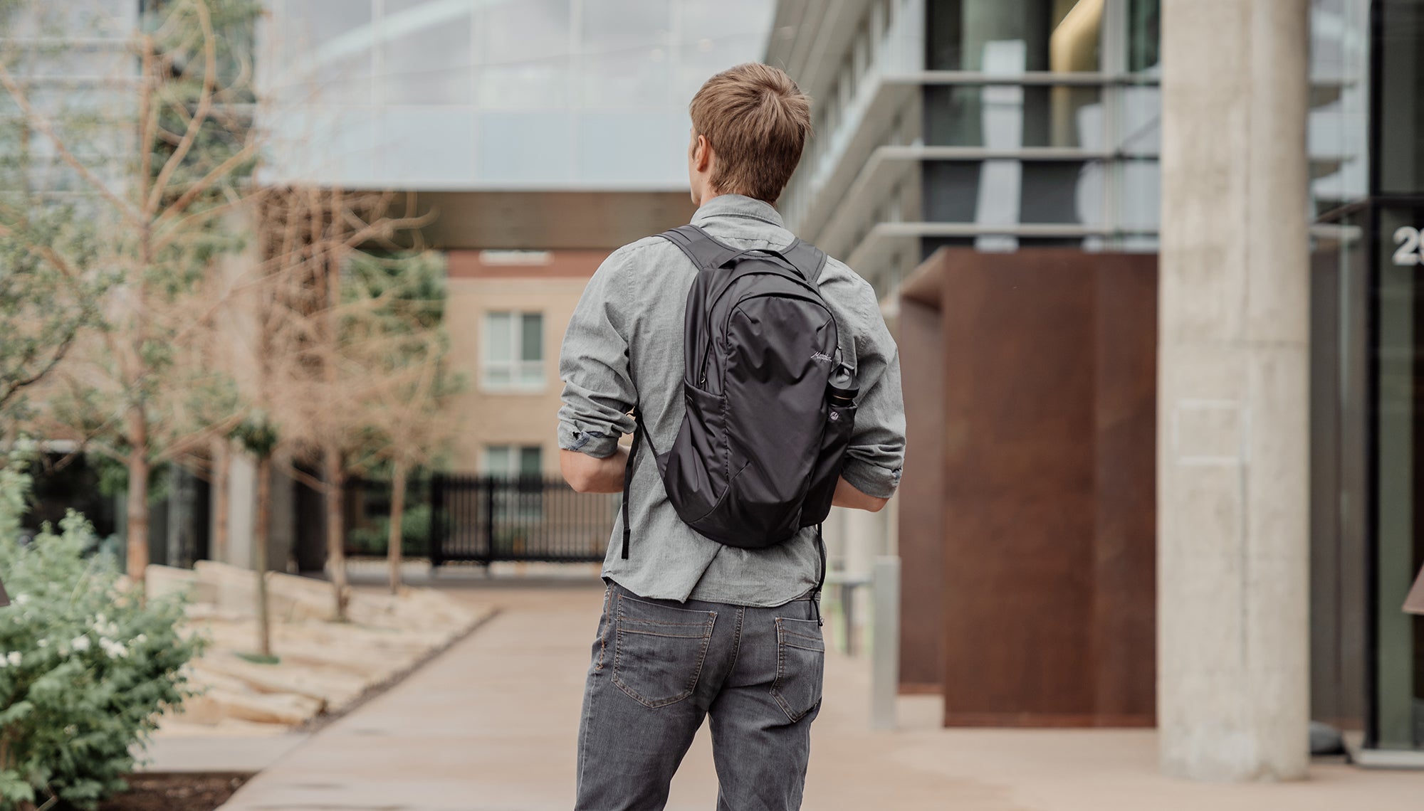 Man in city, wearing black packpack