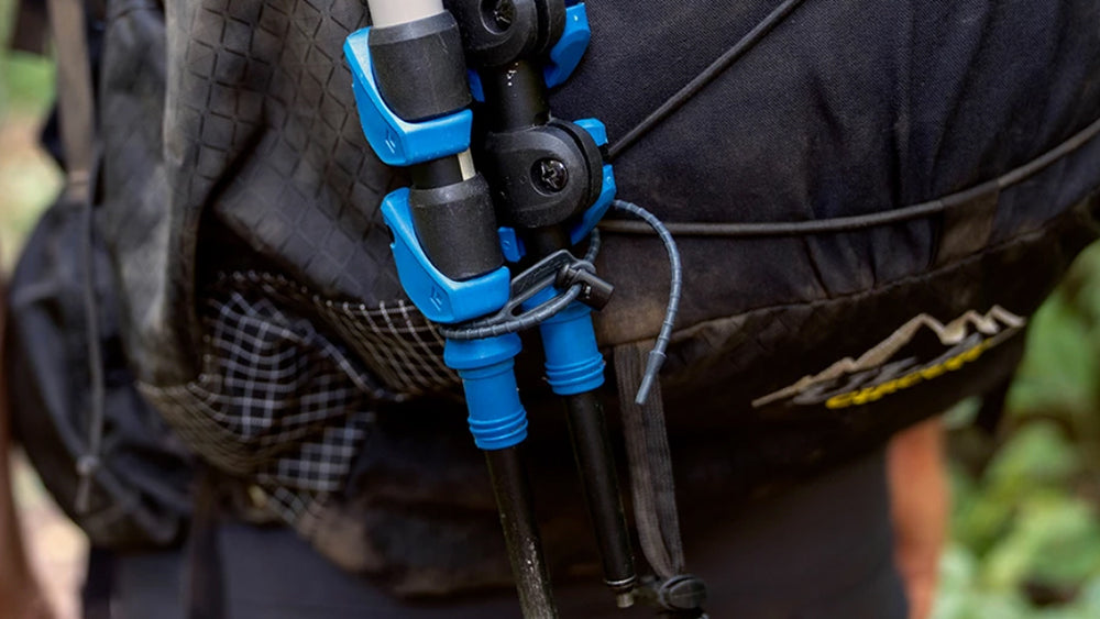 Re-ties attaching hiking poles to backpack
