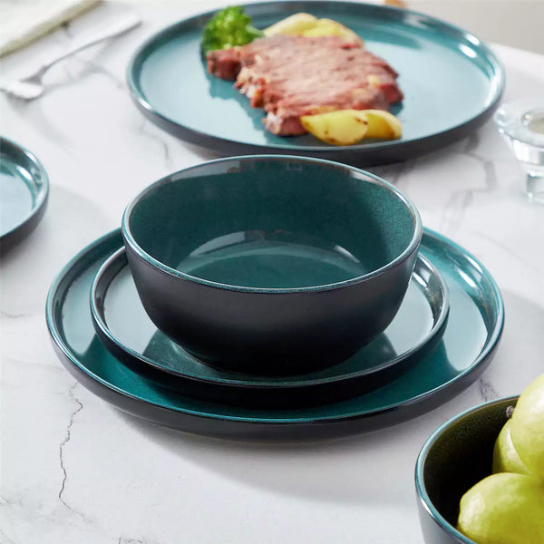 Playa 18-piece glossy dinnerware set, stacked plates and bowls, teal interiors, matte black exterior, serves six