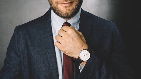 handsome man setting his tie