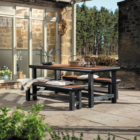 Outdoor dining table and benches, dark stained frame with wooden bamboo table tops.