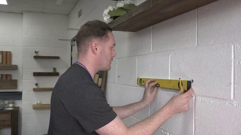 Use a spirit level to decide where mantel is going