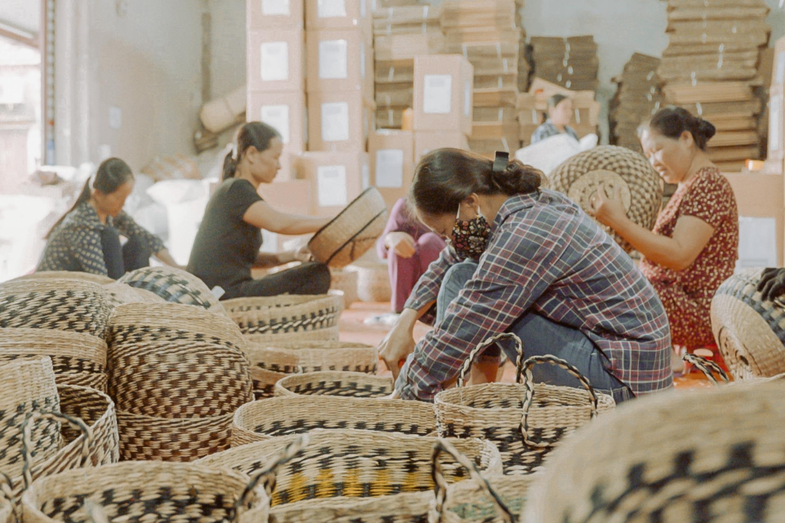 people are weaving baskets