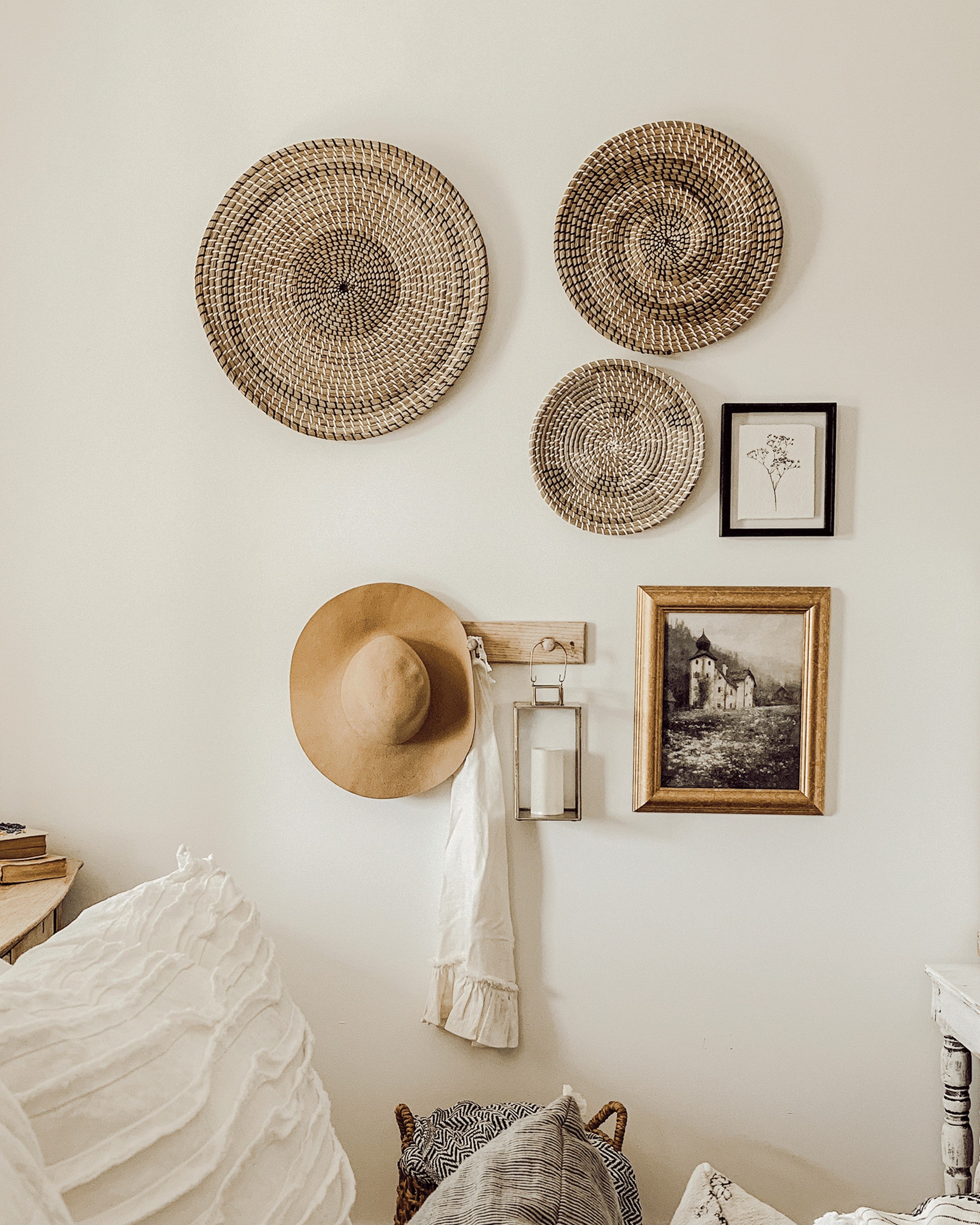 a hat among wall baskets and picture frame