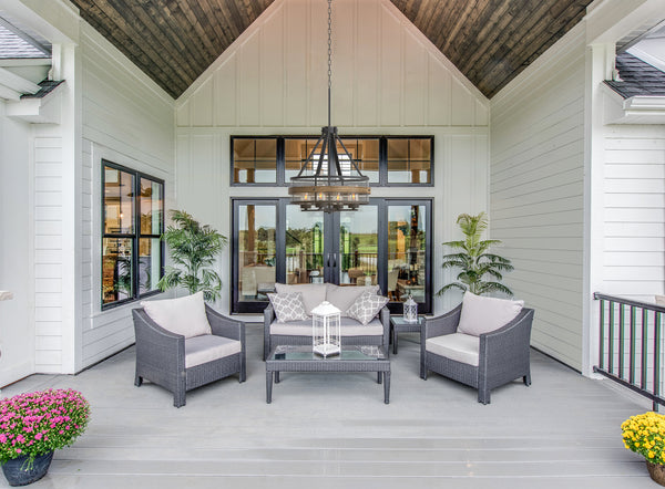 outdoor drum chandelier hanging on a patio above table and chairs